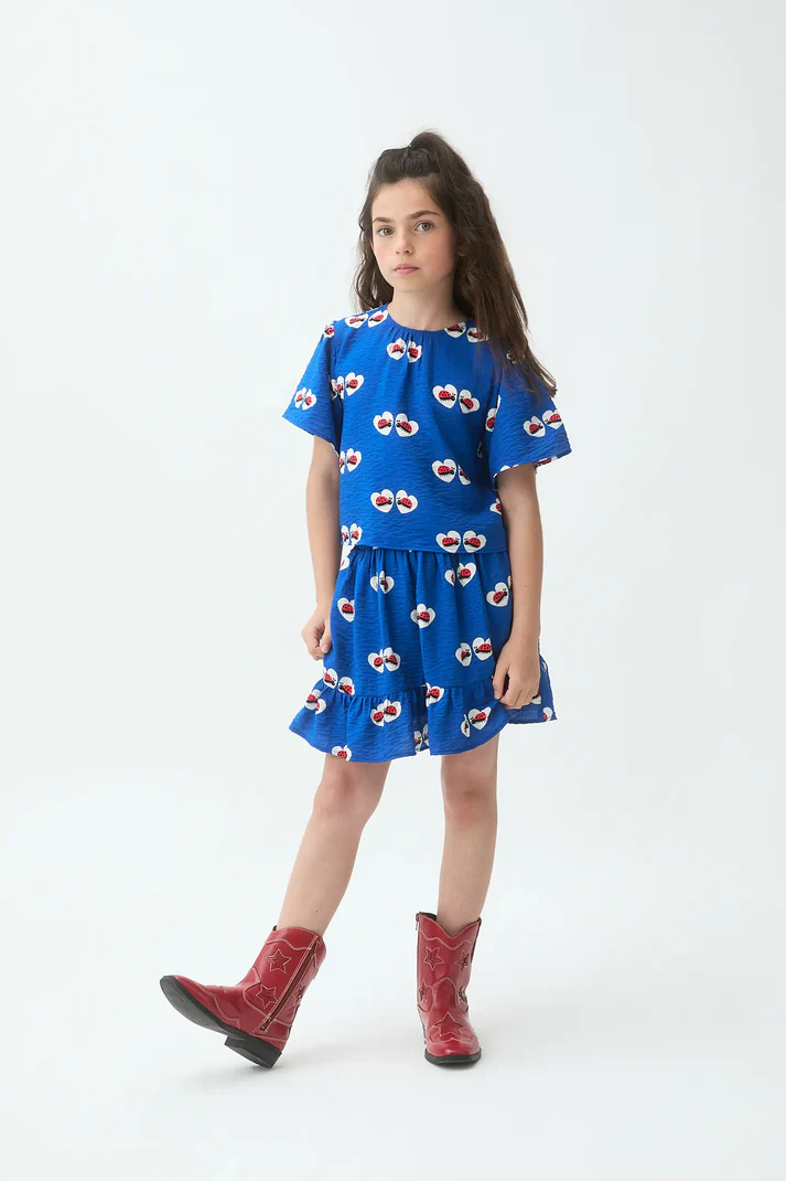 Falda corta de niña de tejido crepé con estampado coccinella.